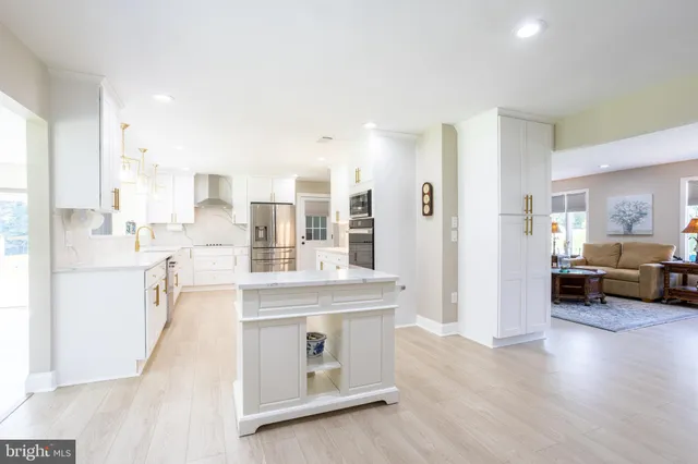 a kitchen with granite countertop a stove and a refrigerator
