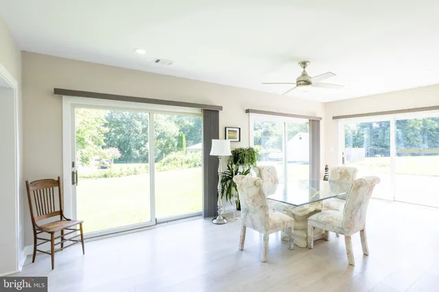 a living room with furniture a flat screen tv and a large window