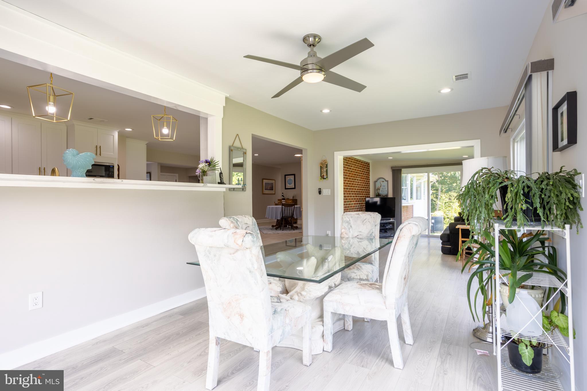 13829 Manor Glen Road Baldwin, MD 21013 - Photo 22 of 82 a view of a dining room with furniture and a potted plant