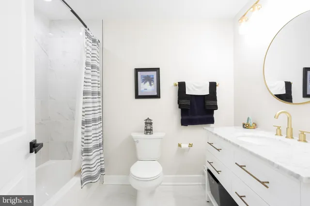 a view of a livingroom with a chair and front door