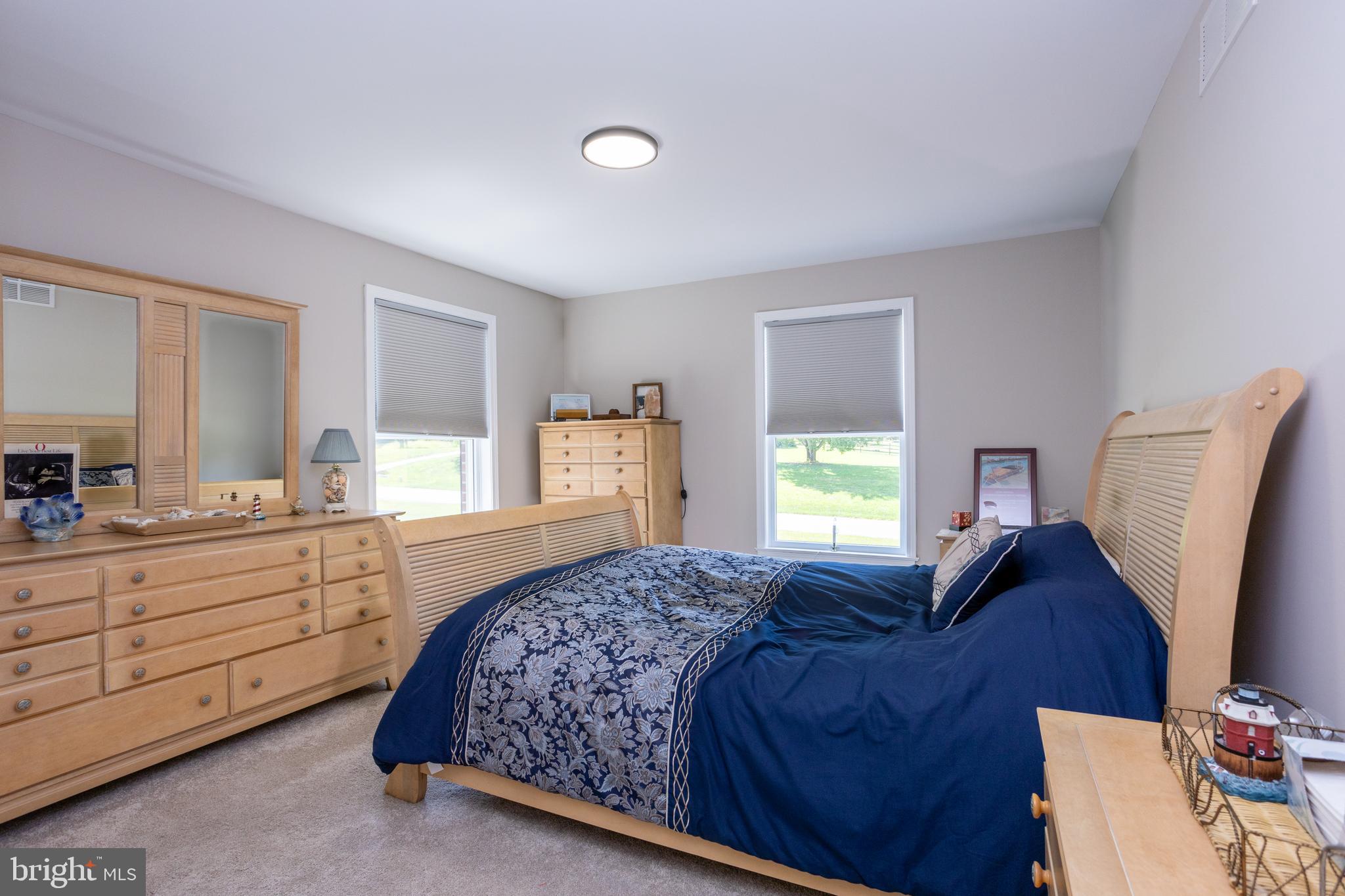 13829 Manor Glen Road Baldwin, MD 21013 - Photo 49 of 82 a bedroom with a large bed and a dresser