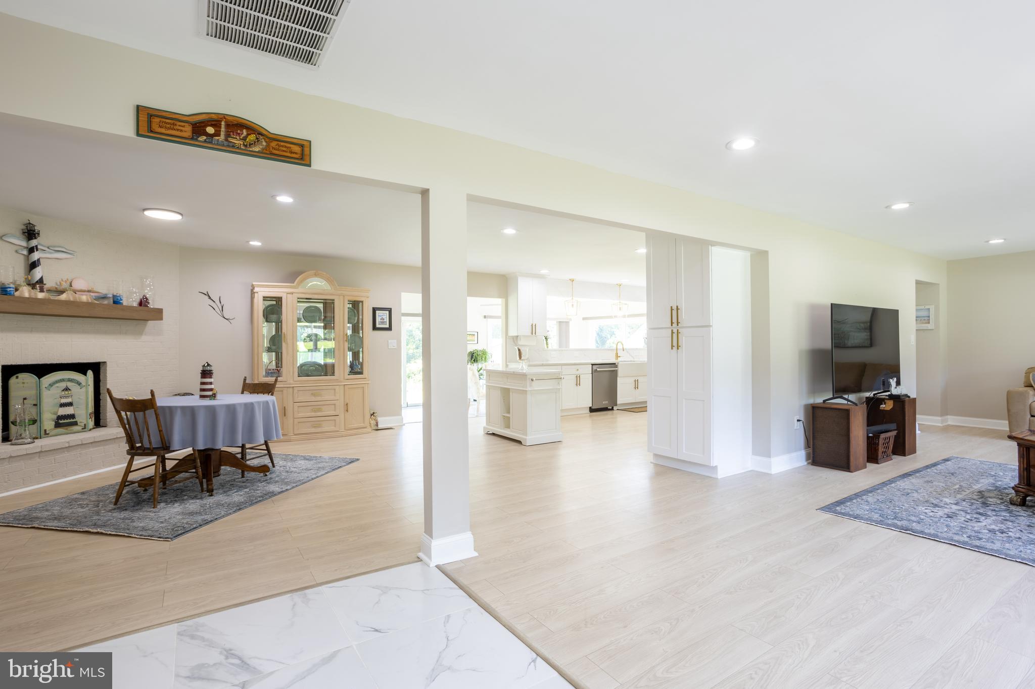 13829 Manor Glen Road Baldwin, MD 21013 - Photo 82 of 82 a view of a living room a dining room wooden floor and a flat screen tv