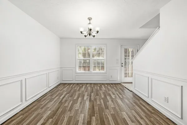 an empty room with a ceiling fan and window