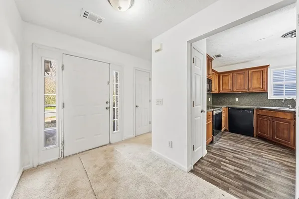 a view of a kitchen from the hallway