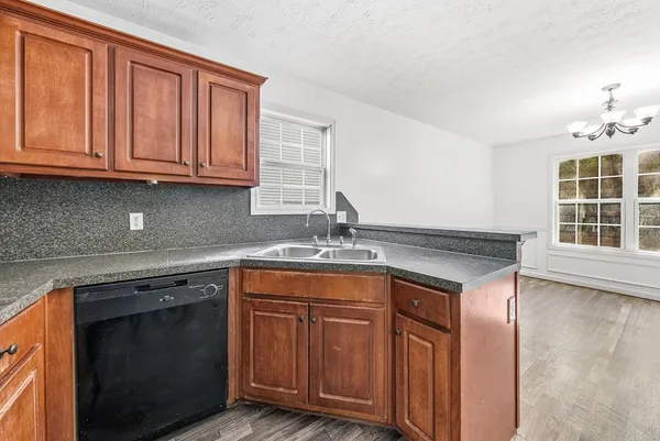 a kitchen with stainless steel appliances granite countertop a sink stove and cabinets