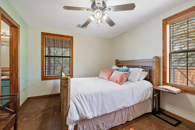 a bedroom with a bed and a large window