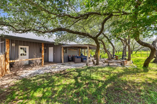 a view of a house with backyard porch and sitting area