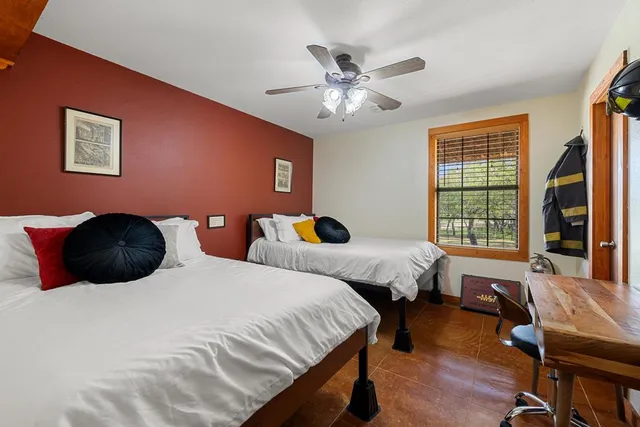 a large bedroom with two beds and a window