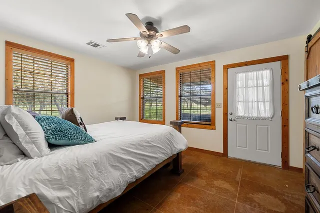 a bedroom with a large bed and a large window