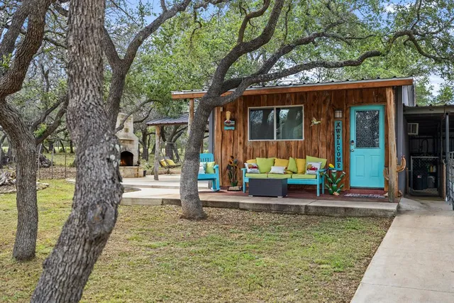 a view of a house with a yard balcony and tree s