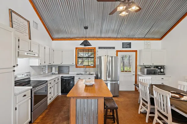 a kitchen with stainless steel appliances a stove a sink dishwasher and a refrigerator