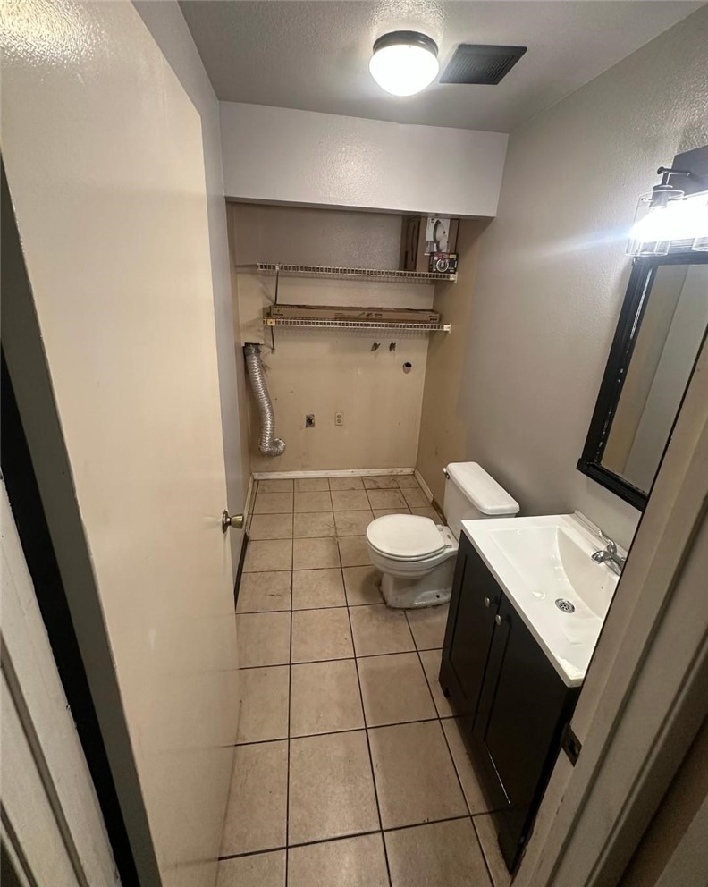 155 South Wilmington Avenue, Unit C Compton, CA 90220 - Photo 24 of 26 a bathroom with a sink a toilet and a mirror