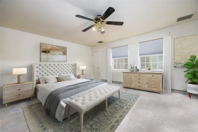 a bedroom with a bed and a couch