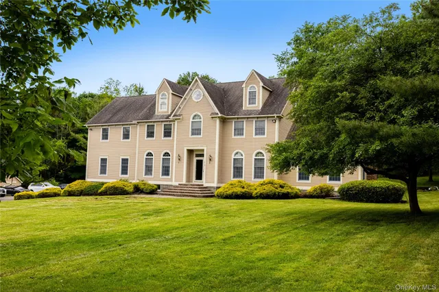 a view of staircase with lots of frames and couches