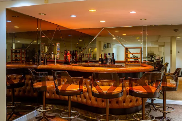 an aerial view of a house with a yard swimming pool and outdoor seating