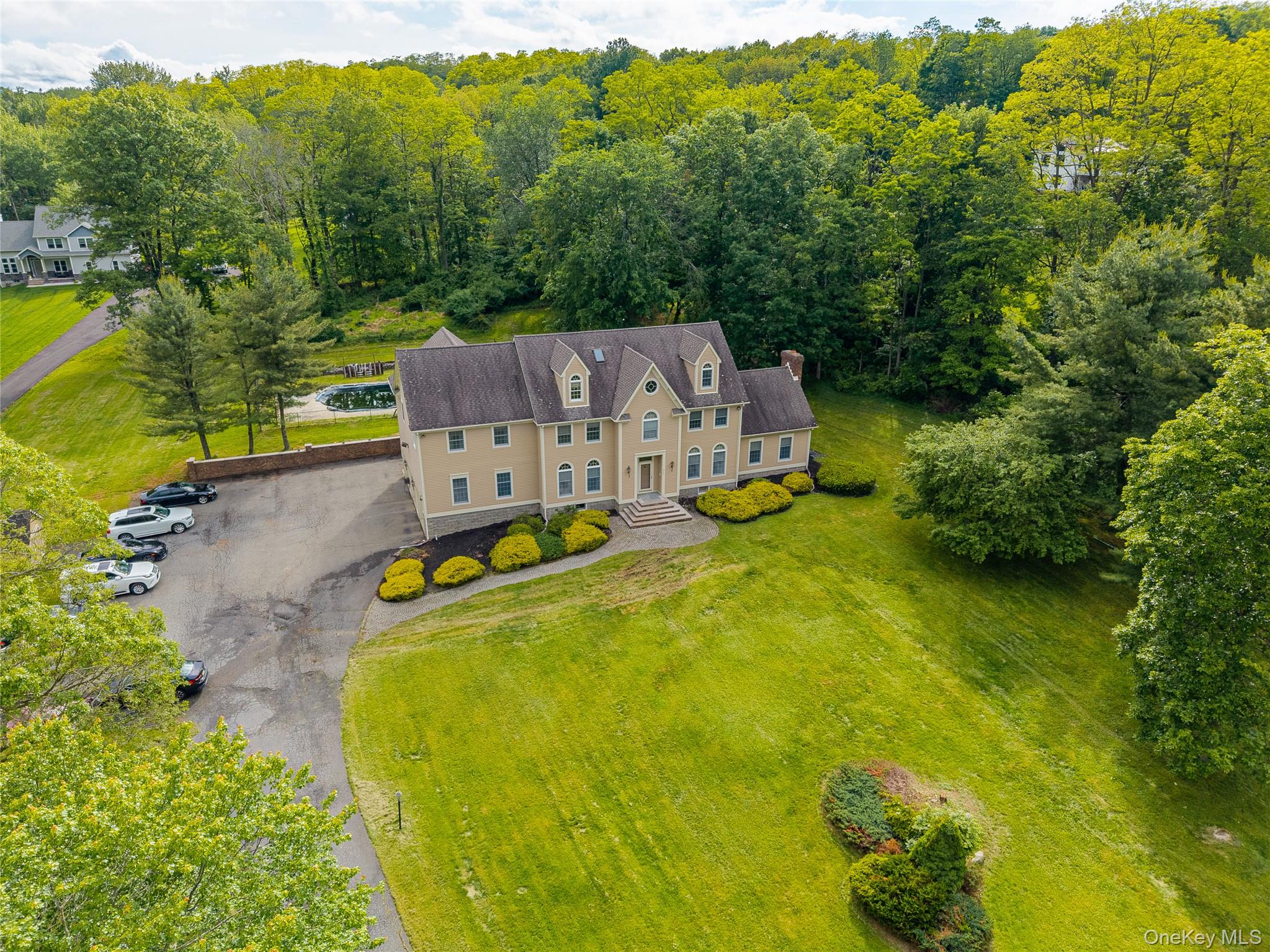 219 Maple Avenue Monroe, NY 10950 - Photo 38 of 40 an aerial view of a house with swimming pool and large trees