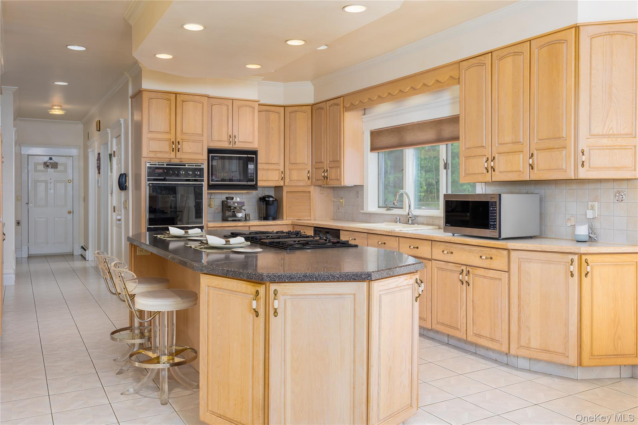219 Maple Avenue Monroe, NY 10950 - Photo 7 of 40 a kitchen with stainless steel appliances granite countertop a stove a sink and a microwave