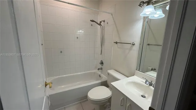 a bathroom with a granite countertop sink a toilet and shower