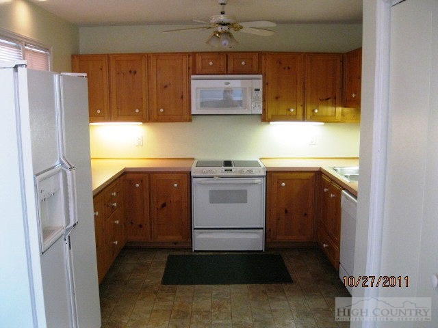153 Alpine Court Boone, NC 28607 - Photo 2 of 13 a kitchen with a refrigerator sink and cabinets