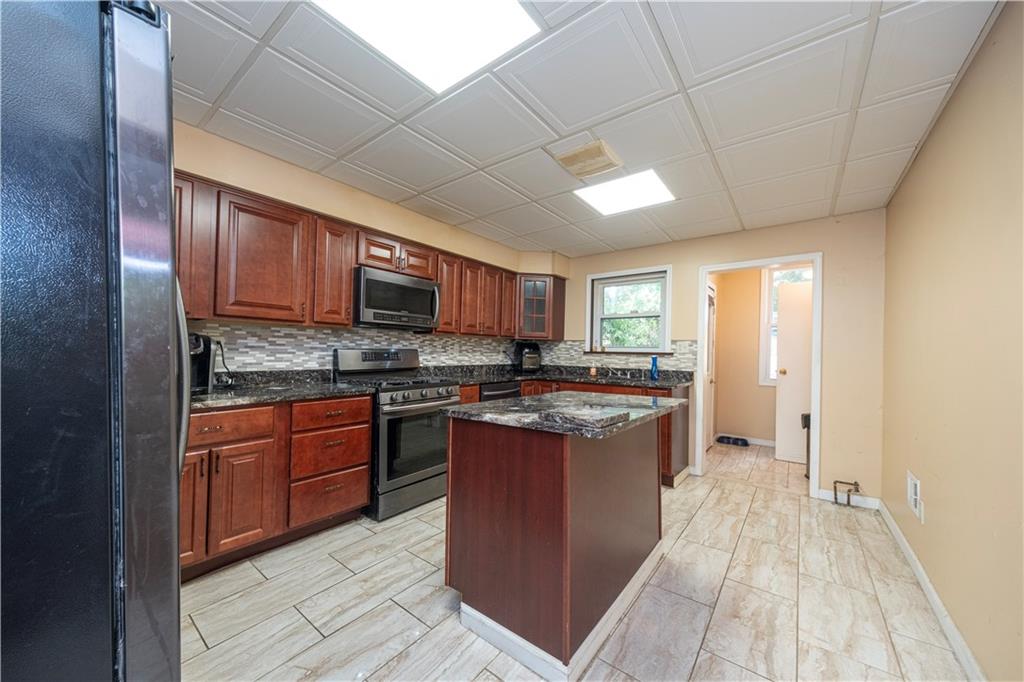 33 5th Street Pittsburgh, PA 15215 - Photo 12 of 43 a large kitchen with stainless steel appliances granite countertop lots of counter top space and wooden floor