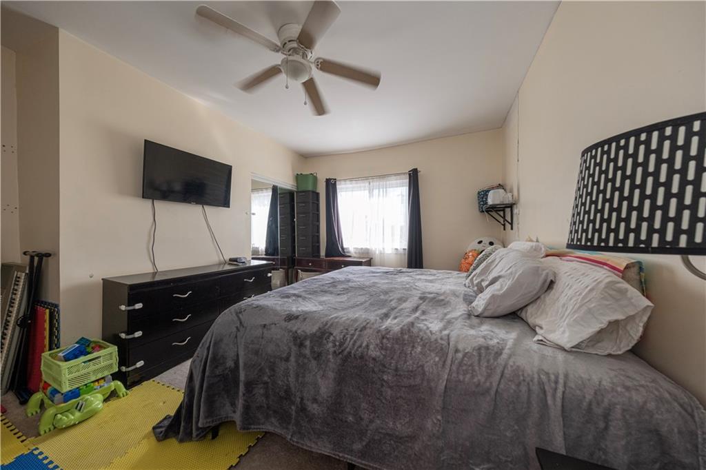 33 5th Street Pittsburgh, PA 15215 - Photo 15 of 43 a bedroom with a bed and a flat screen tv