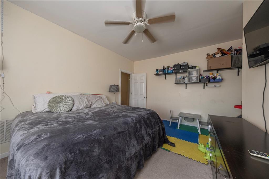 33 5th Street Pittsburgh, PA 15215 - Photo 17 of 43 a bed sitting in a bedroom next to a window