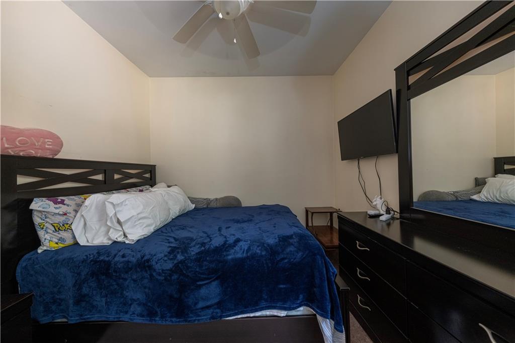 33 5th Street Pittsburgh, PA 15215 - Photo 18 of 43 a bedroom with a bed and a lamp on the dresser