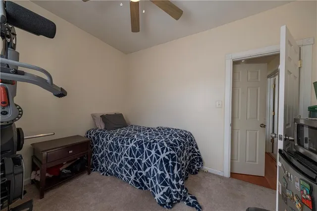 a bedroom with a bed and a television