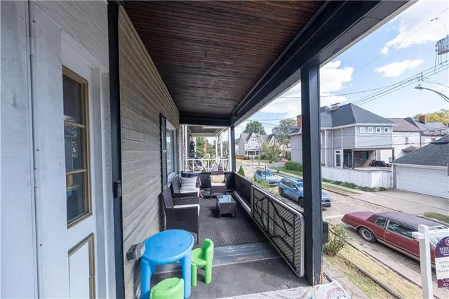 a view of a porch with furniture and a yard
