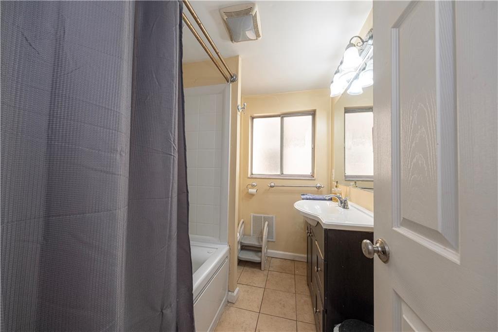 33 5th Street Pittsburgh, PA 15215 - Photo 22 of 43 a bathroom with a double vanity sink a mirror and a bathtub