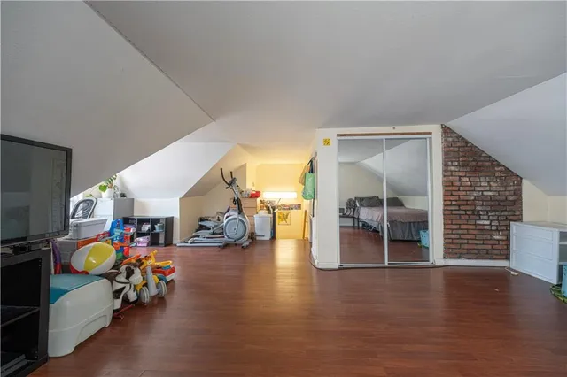 a bed room with a bed and a chair