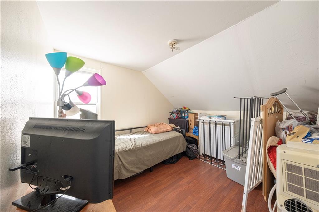33 5th Street Pittsburgh, PA 15215 - Photo 27 of 43 a bedroom with a bed and wooden floor