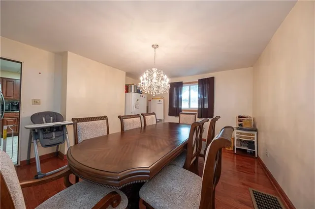 a view of a dining room with furniture and chandelier