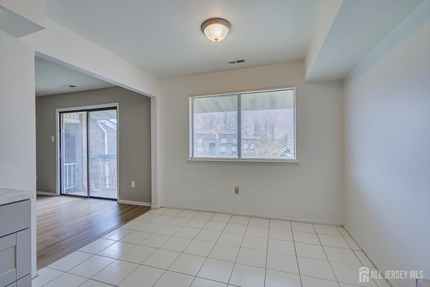 1607 Edison Glen Terrace Edison, NJ 08837 - Photo 11 of 19 an empty room with wooden floor and windows