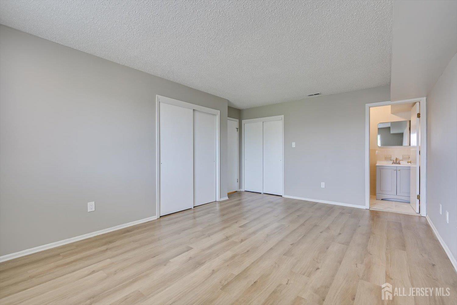 1607 Edison Glen Terrace Edison, NJ 08837 - Photo 12 of 19 a view of an empty room with wooden floor