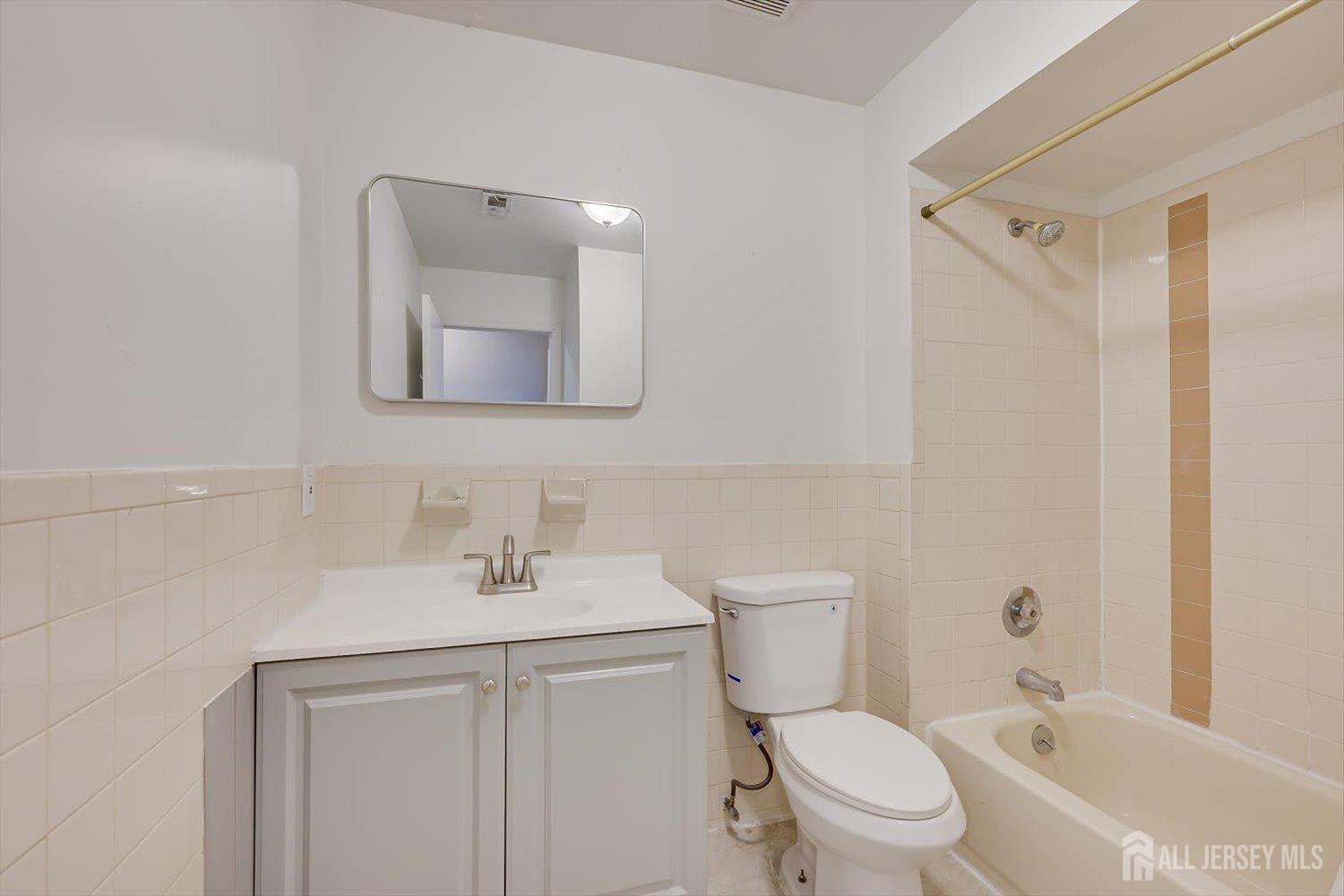 1607 Edison Glen Terrace Edison, NJ 08837 - Photo 17 of 19 a bathroom with a toilet sink and mirror