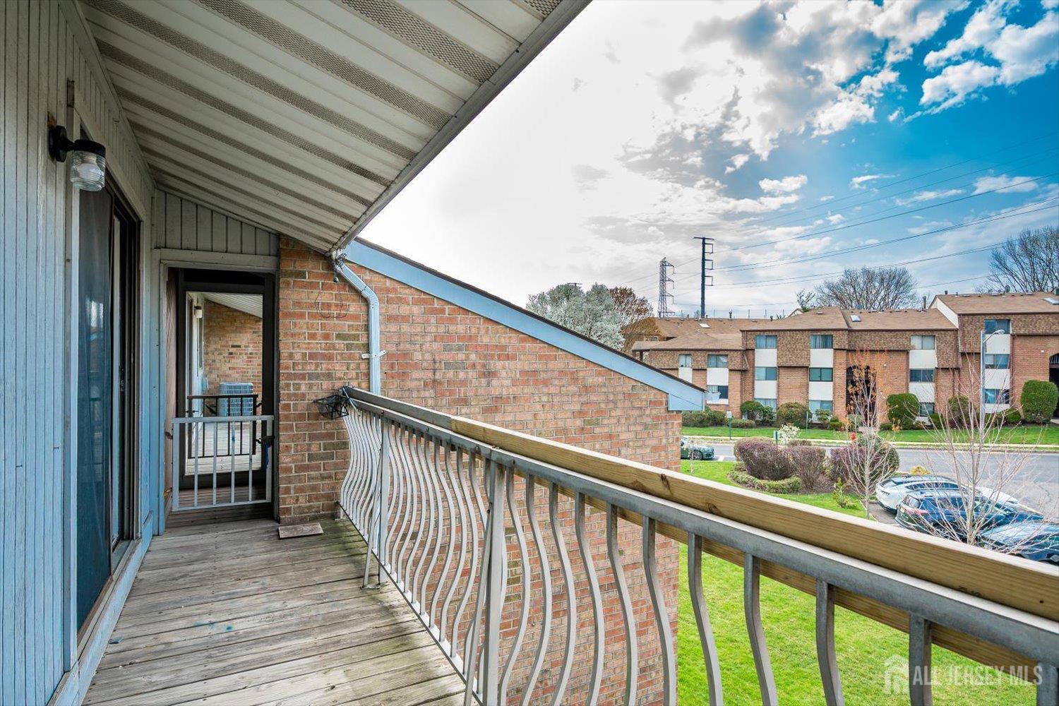 1607 Edison Glen Terrace Edison, NJ 08837 - Photo 19 of 19 a view of a balcony with wooden floor and fence