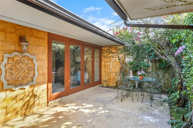 a view of a chairs and table in backyard of the house