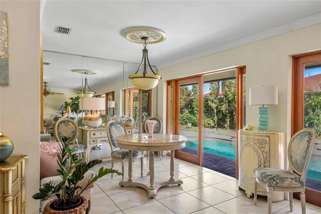 a dining room with furniture a chandelier and wooden floor