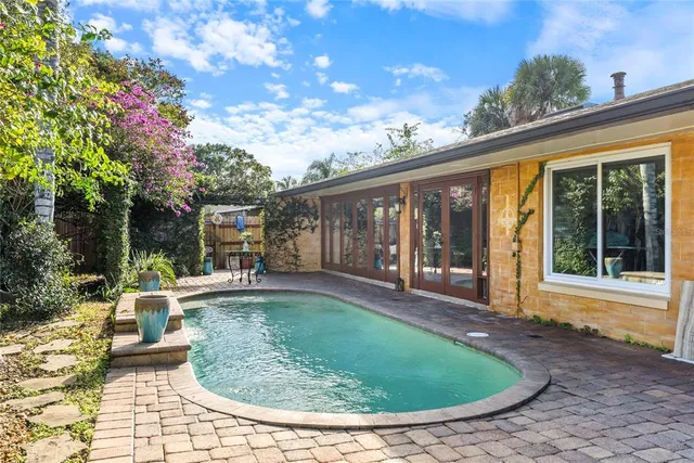 a backyard of a house with table and chairs