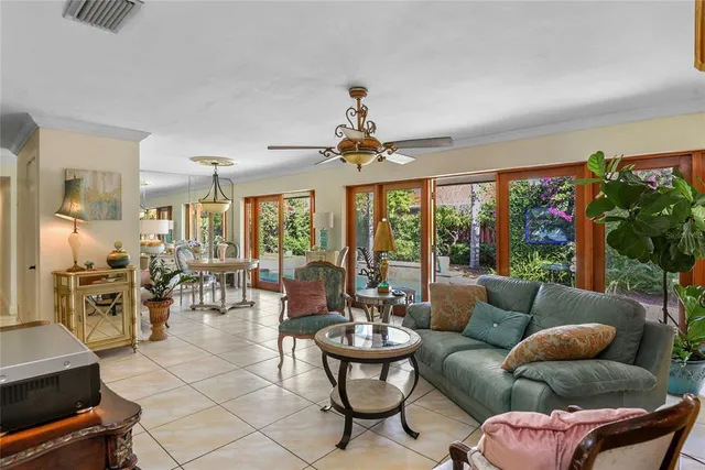 a living room with furniture and floor to ceiling window