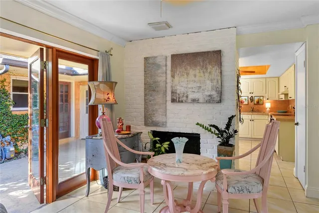 a view of patio with a table and chairs and potted plants