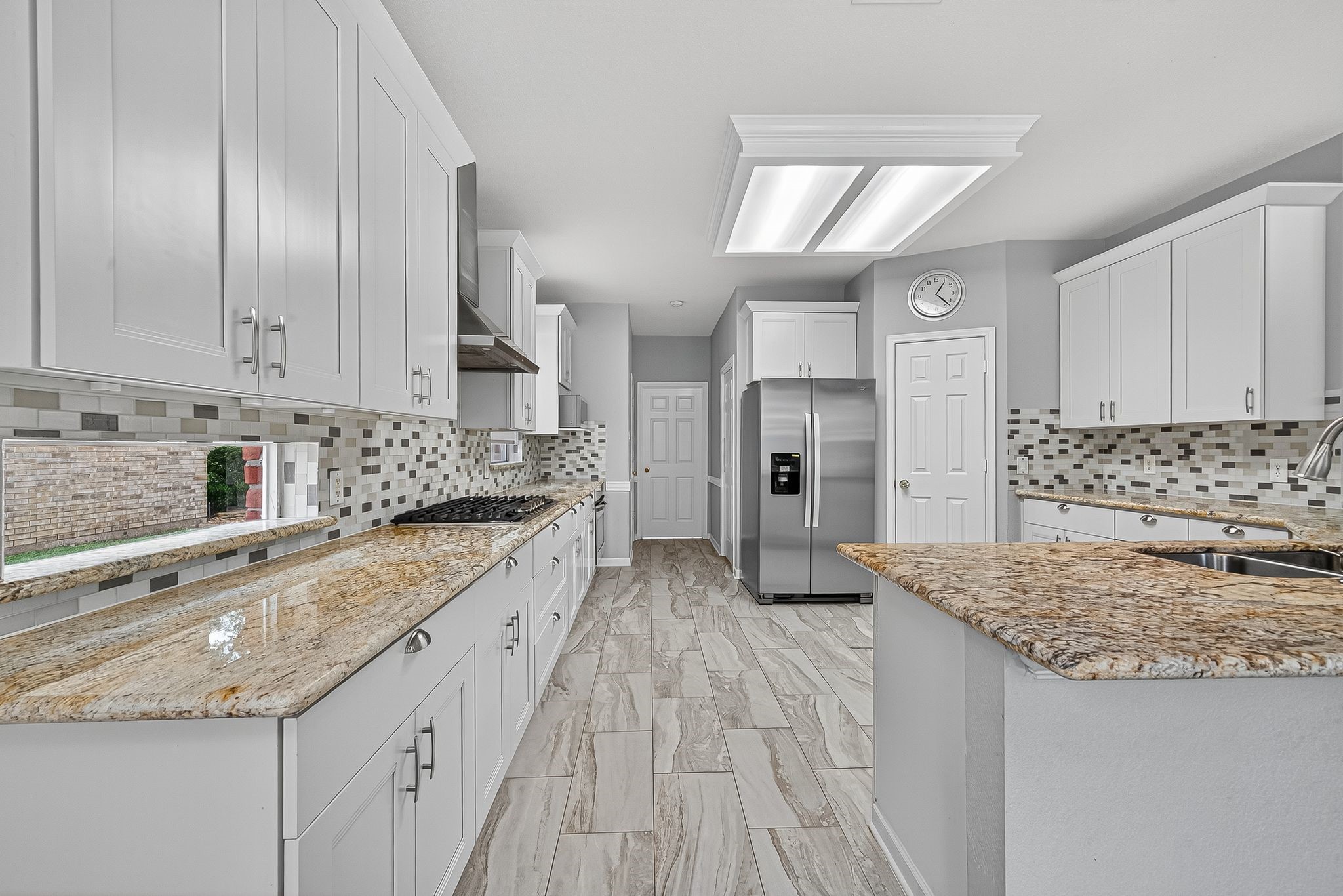 22406 Piper Terrace Lane Katy, TX 77450 - Photo 21 of 44 a large kitchen with granite countertop a sink and cabinets