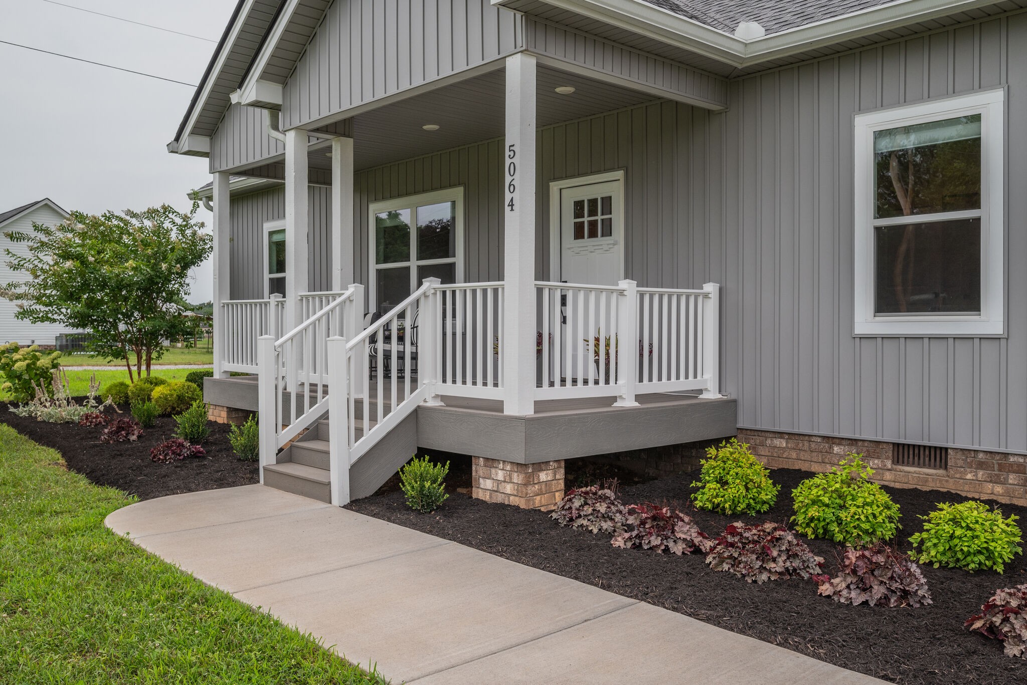 5064 Hyde Road Springfield, TN 37172 - Photo 4 of 26 a view of a house with a small yard and flower plants