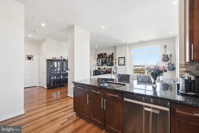 a kitchen with stainless steel appliances granite countertop a sink counter space and cabinets