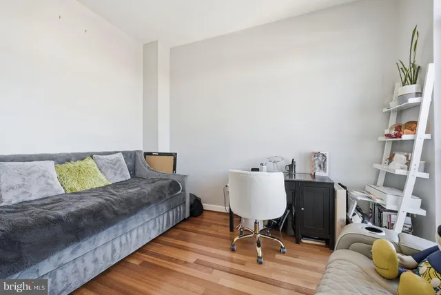 a living room with a couch and a coffee table with wooden floor