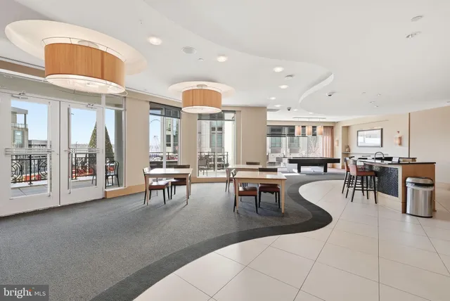 a lobby with furniture and view of kitchen