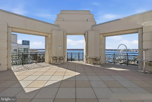 a spacious bedroom with a bed a table and painting on the wall