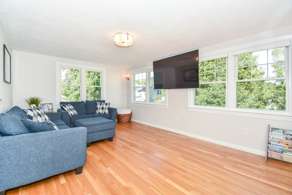 72 Evans Street, Unit 72 Watertown, MA 02472 - Photo 11 of 34 a living room with furniture and a flat screen tv