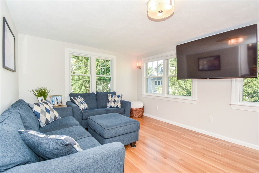 72 Evans Street, Unit 72 Watertown, MA 02472 - Photo 13 of 34 a living room with furniture and a flat screen tv